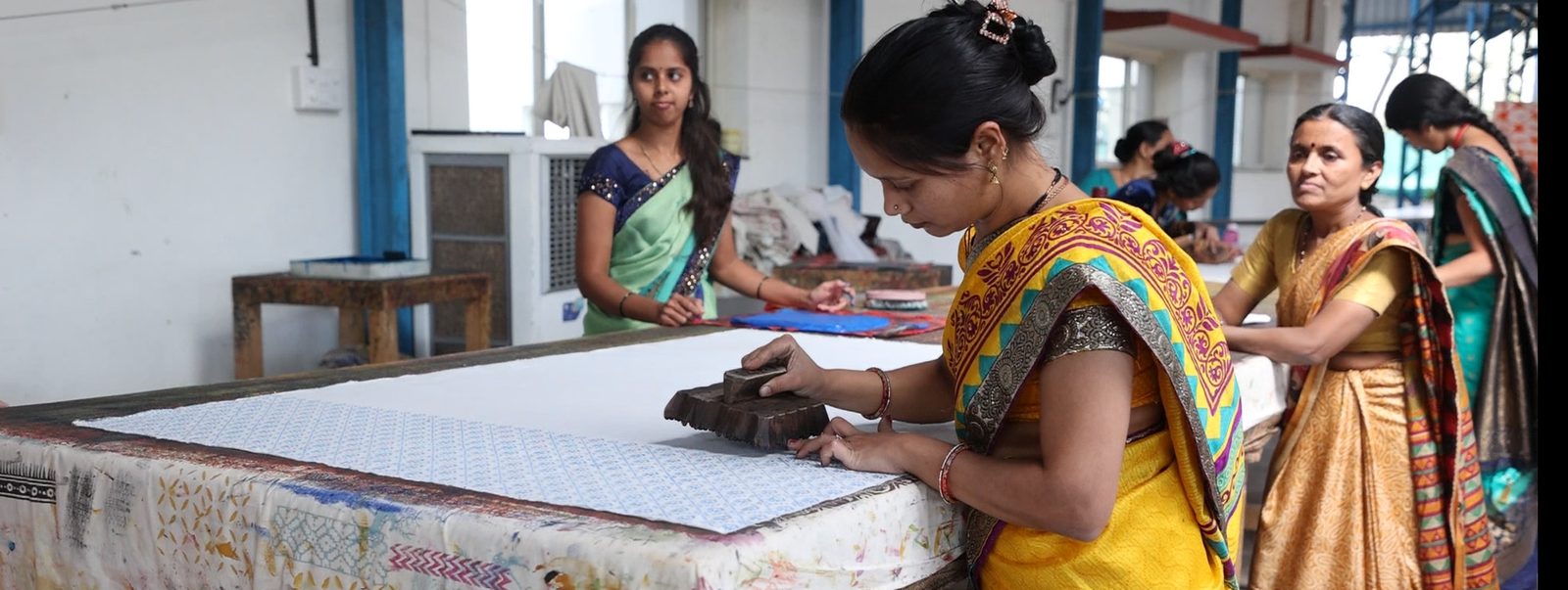 AKAI artisans printing and embroidering fabric together at the Jeewan Jyoti workshop in Velhe, Pune